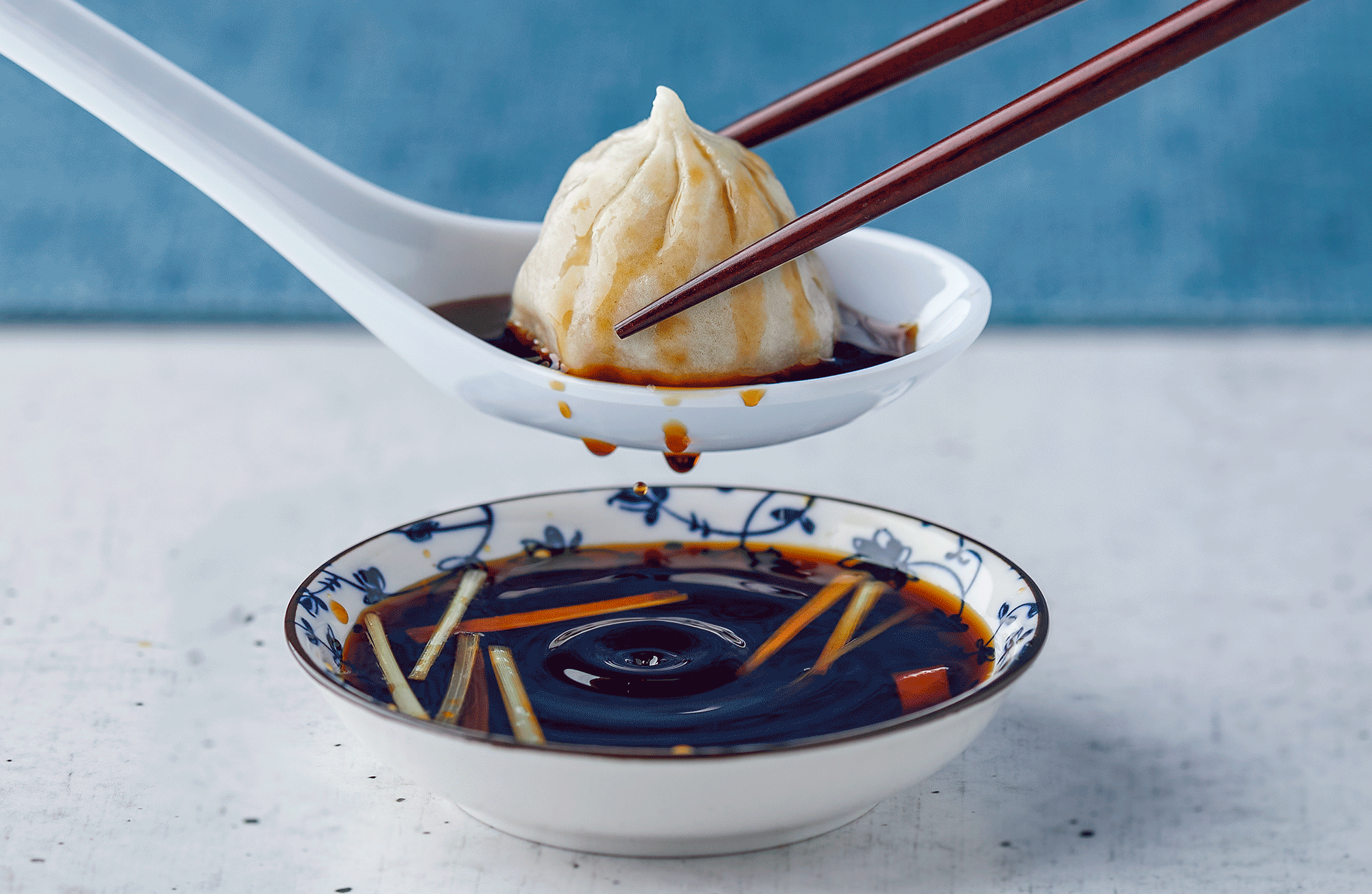 Marlin Connections Products and Services: Dumpling being dipped in sauce